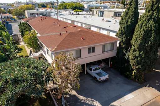 an aerial view of a house with a car parked in front of it