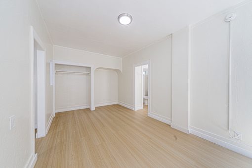 A room with white walls and wooden flooring.