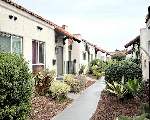 A row of houses with a pathway in the middle.