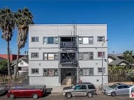a large white building with cars parked in front of it
