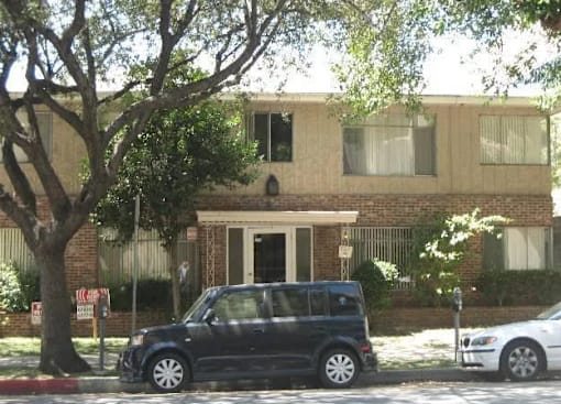 a black car parked in front of a house