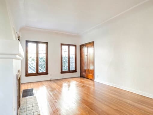 A room with wooden floors and white walls.