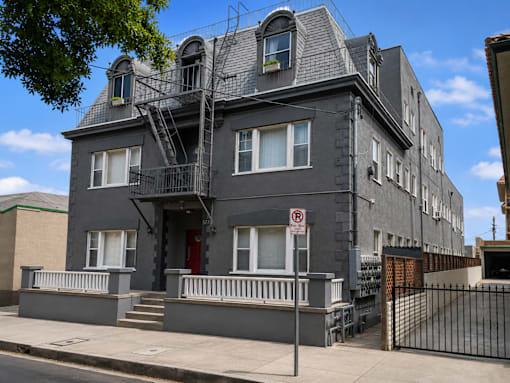 a building with a fire escape on the side of a street