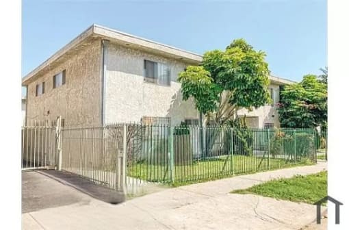 a house with a fence in front of it