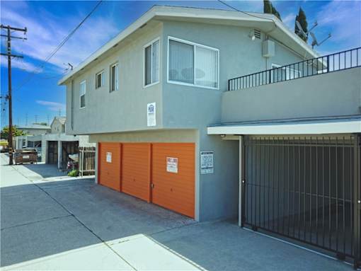 the front of a house with a garage and a gate