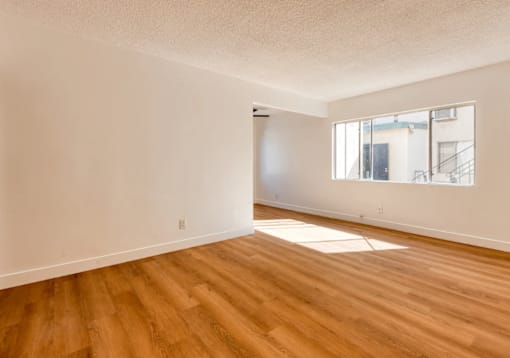 A room with wooden floors and a window.