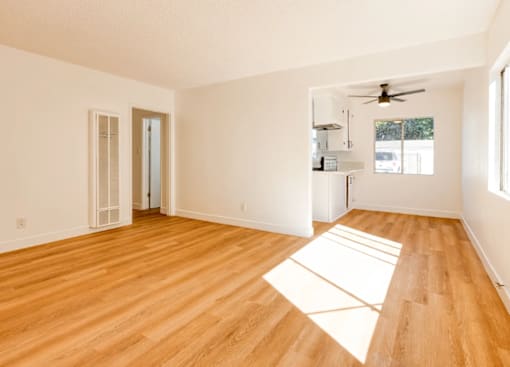 A room with wooden floors and white walls.