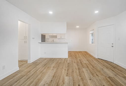 A room with wooden floors and white walls.