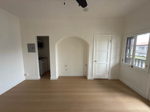 A room with a wooden floor and white walls.