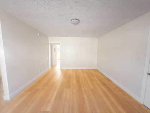 A room with wooden floors and white walls.