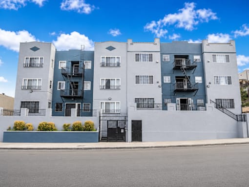 A modern apartment building with balconies and staircases.