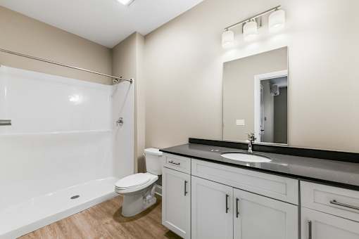 a bathroom with a sink and a toilet and a window
