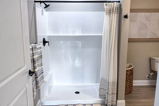 A white bathroom with a glass shower door.