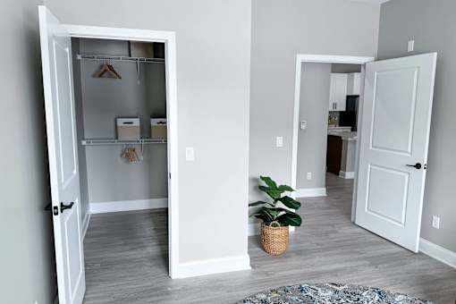 A room with a white door open to a hallway.