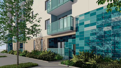 A modern building with a blue tiled wall and a tree in front.