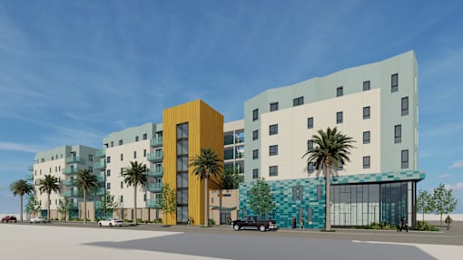 A modern building complex with a yellow and blue building in the foreground.
