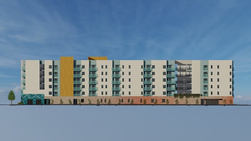 A row of modern buildings with a tree in the foreground.