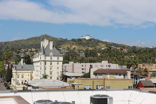 A large white castle-like building sits in the middle of a town.