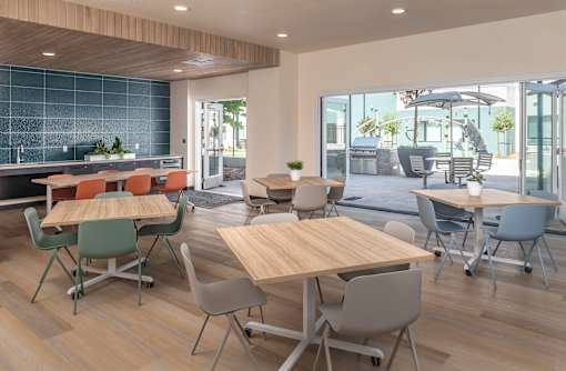 A modern dining area with wooden tables and chairs.