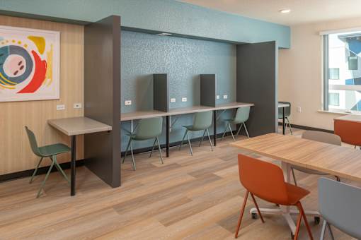 A conference room with a long table, chairs, and a speaker system.