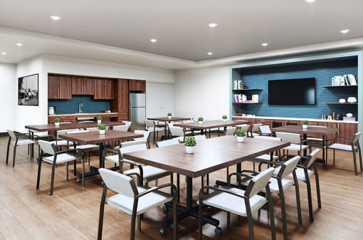 a conference room with tables and chairs and a television