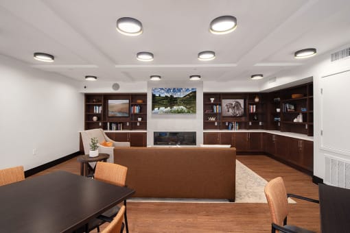a living room with a fireplace and a table and chairs