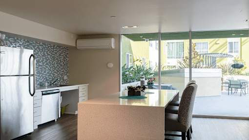 a kitchen and dining area with a white refrigerator and a table