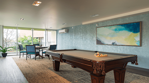 a game room with a pool table and a painting