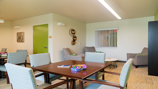 a dining room with a wooden table and chairs