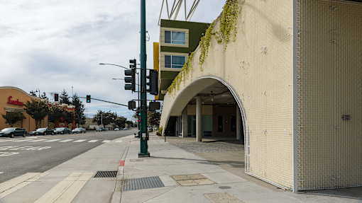 a building with an arch on the side of a street