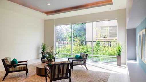 a living room with chairs and a table and a large window