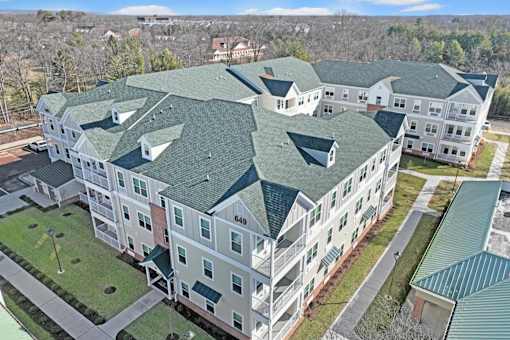 an aerial view of an apartment building with green roofs at The Franklin at Hillsborough Apartments, Hillsborough, NJ