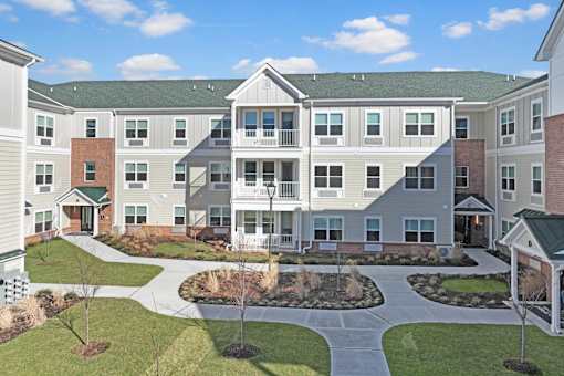 an exterior view of an apartment building with a courtyard at The Franklin at Hillsborough Apartments, NJ,08844