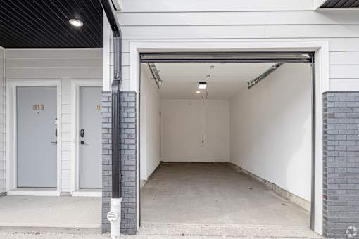 A white garage door with the number 813 on it.