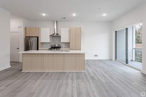 A modern kitchen with a stainless steel refrigerator and a wooden island.