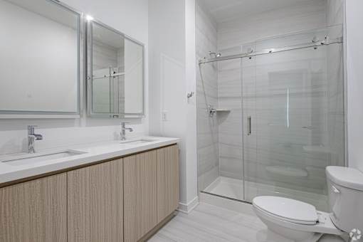 A white bathroom with a walk in shower.
