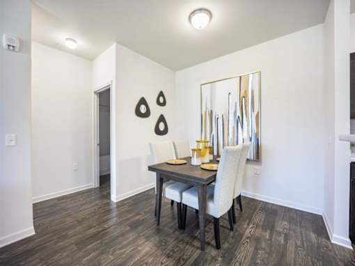 a dining room with a table and chairs at The Maddox Apartments, Centerton, AR, 72719