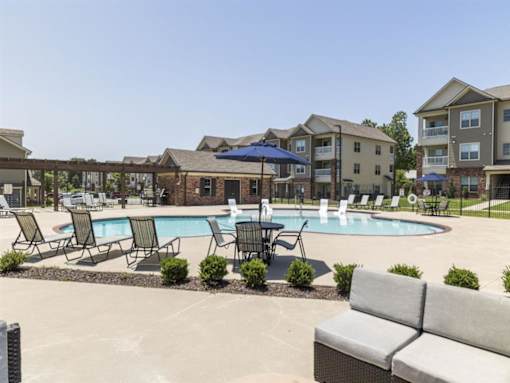 our apartments offer a swimming pool with chairs and umbrellas at The Maddox Apartments, Centerton, AR, 72719