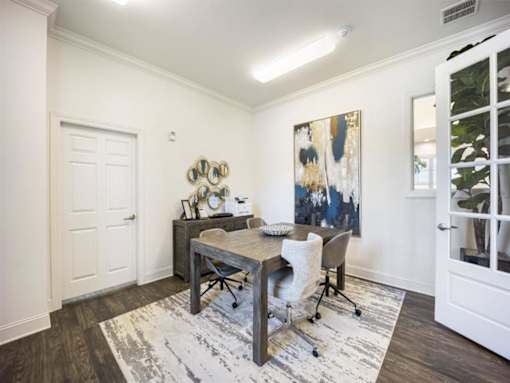a dining room with a table and chairs at The Maddox Apartments, Centerton, AR, 72719