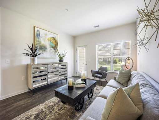 a living room with a couch and a coffee table at The Maddox Apartments, Arkansas