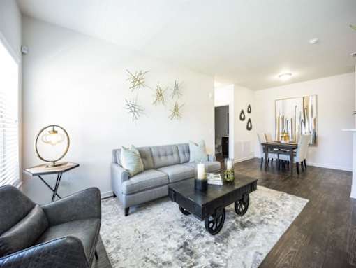 a living room with a couch and a table at The Maddox Apartments, Centerton, Arkansas