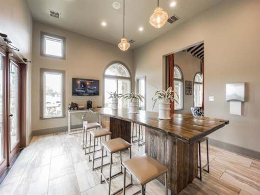 a large kitchen with a bar and stools