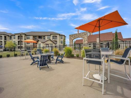 our patio has tables and chairs and umbrellas and is near our building