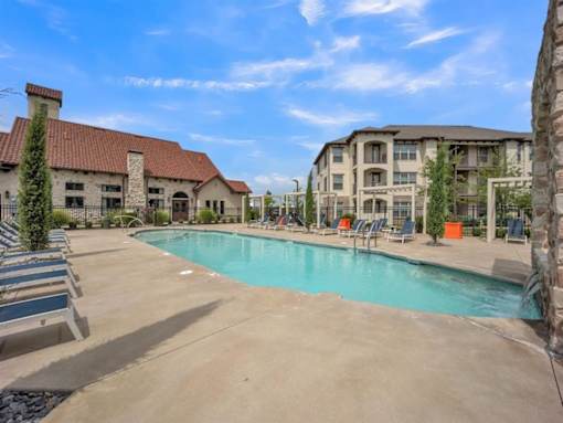 a swimming pool with buildings in the background