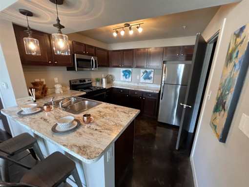 a kitchen with stainless steel appliances and granite counter tops