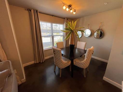 a dining room with a table and chairs