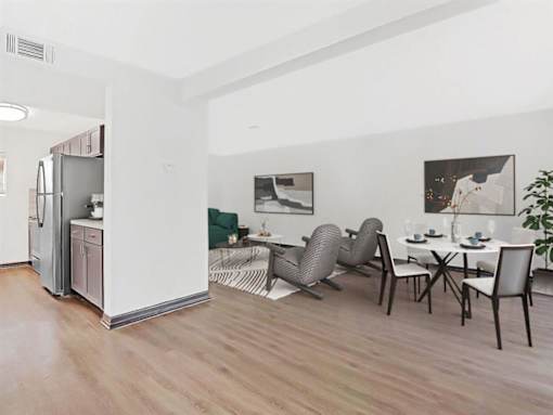 a living room with a kitchen and a table and chairs