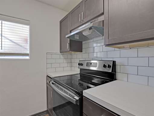a kitchen with a stove and a window