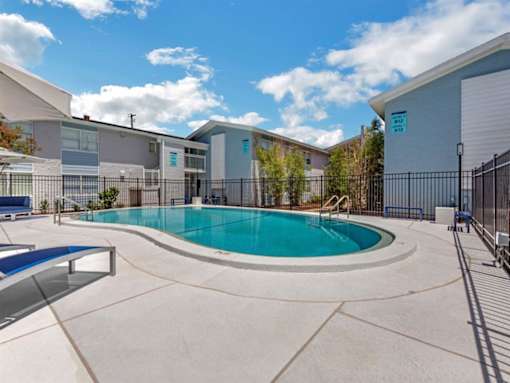 our apartments offer a swimming pool and a patio with chairs
