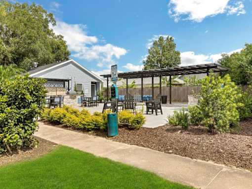 a patio with tables and chairs and a pergola